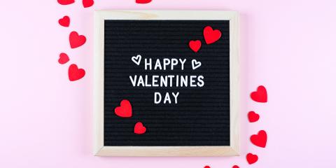 Board with "Happy Valentines Day" written on it. 