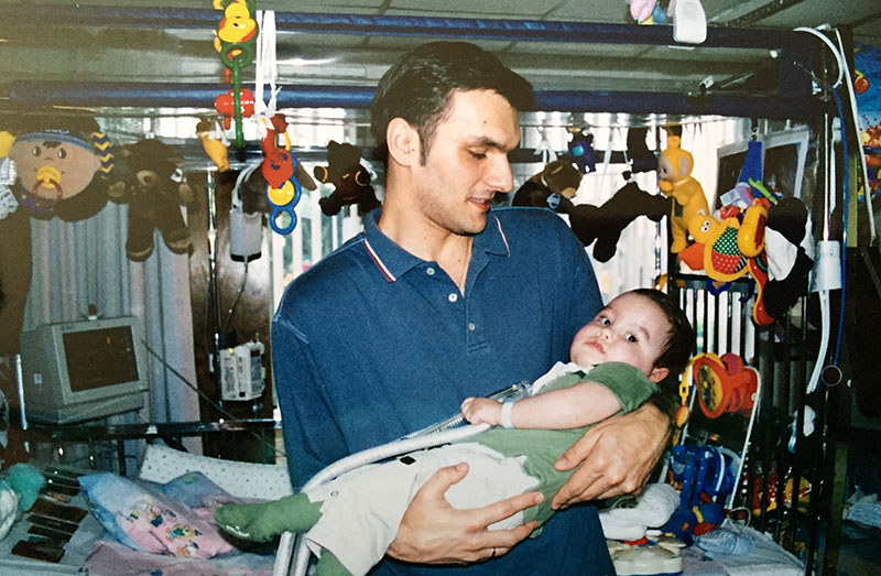 Voya holding Jovan as an infant